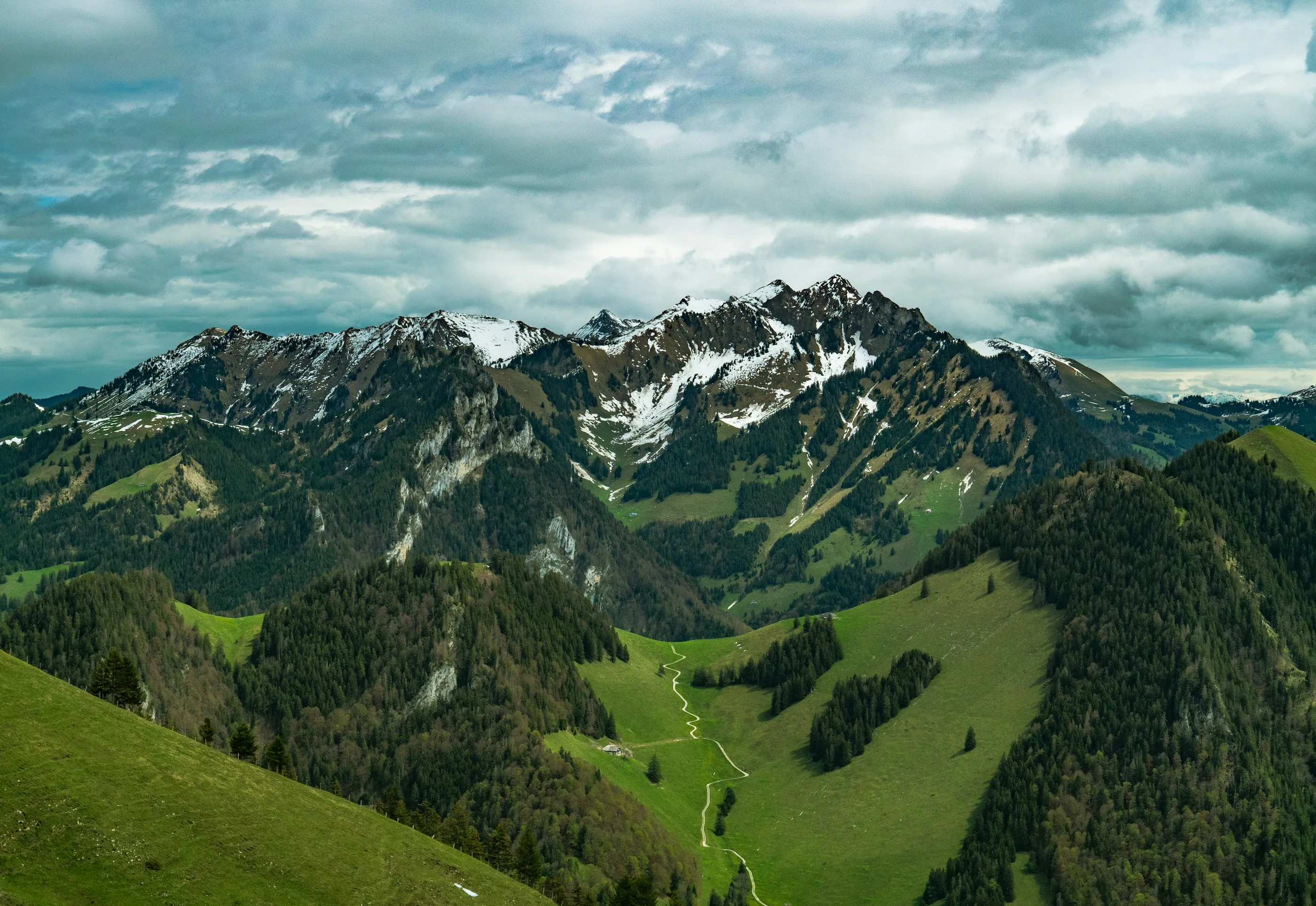 Green alpine ridges under a cloudy sky in Slovenia